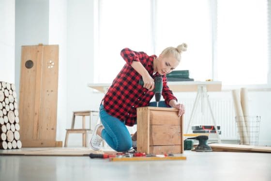 woman doing a diy home project while staying inside