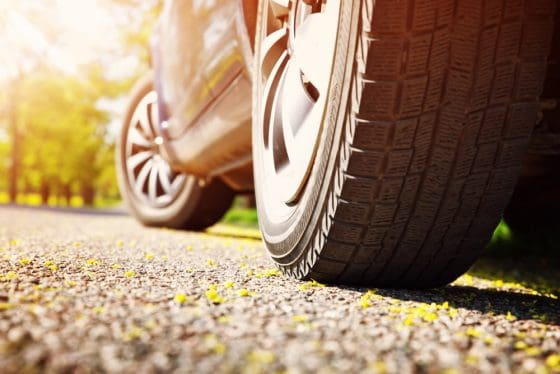 bottom side view of a cars tires on the road