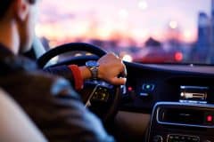 man driving a car at night trying to prevent an accident