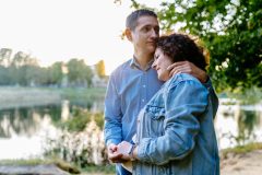 Couple hugging standing by a body of water