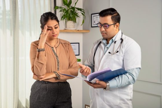 Worried woman talks to doctor about losing her Medicaid in California