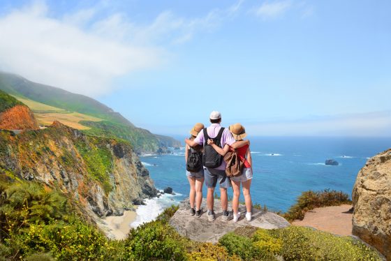 Family trio looks at Big Sur on California road trip