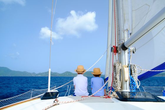 back view of 2 children on a sailboat