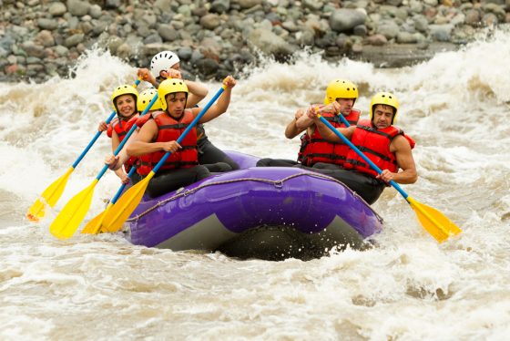 Group of people whitewater rafting