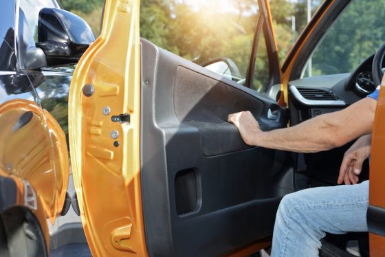 Person opening their car door and bumping it into the car parked next to it - cheap auto insurance in California