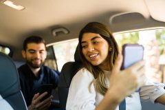 Woman rideshare driver greets her passenger - cheap rideshare insurance in California