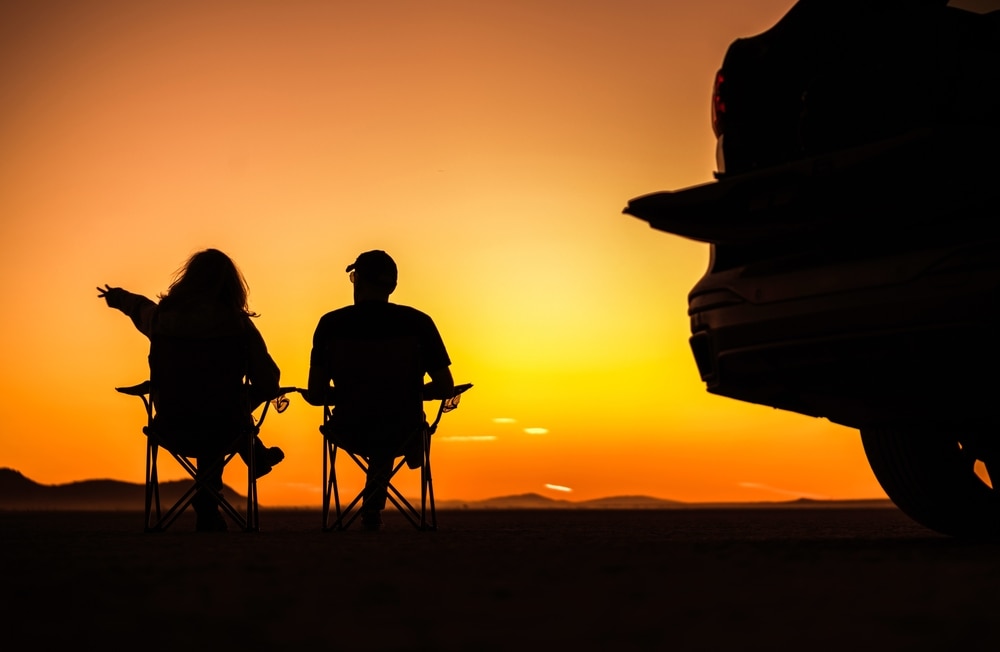 Couple enjoys the sunset at Mojave Desert - cheap car insurance in California