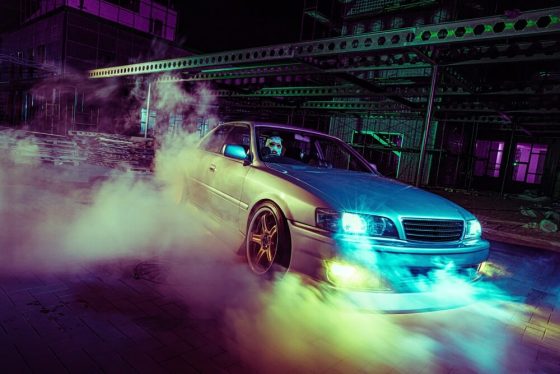 High speed night drift with customized sports car in urban setting, California car modifications and the affect on car insurance.
