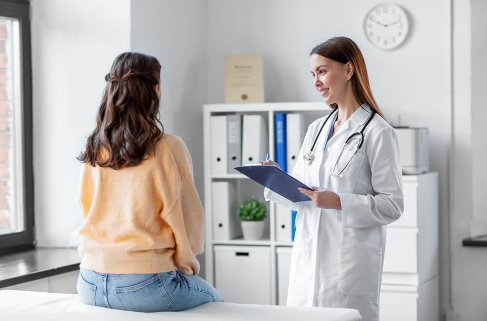 Smiling healthcare worker supporting a patient in hospital with Health Insurance Options for Self-Employed Californians