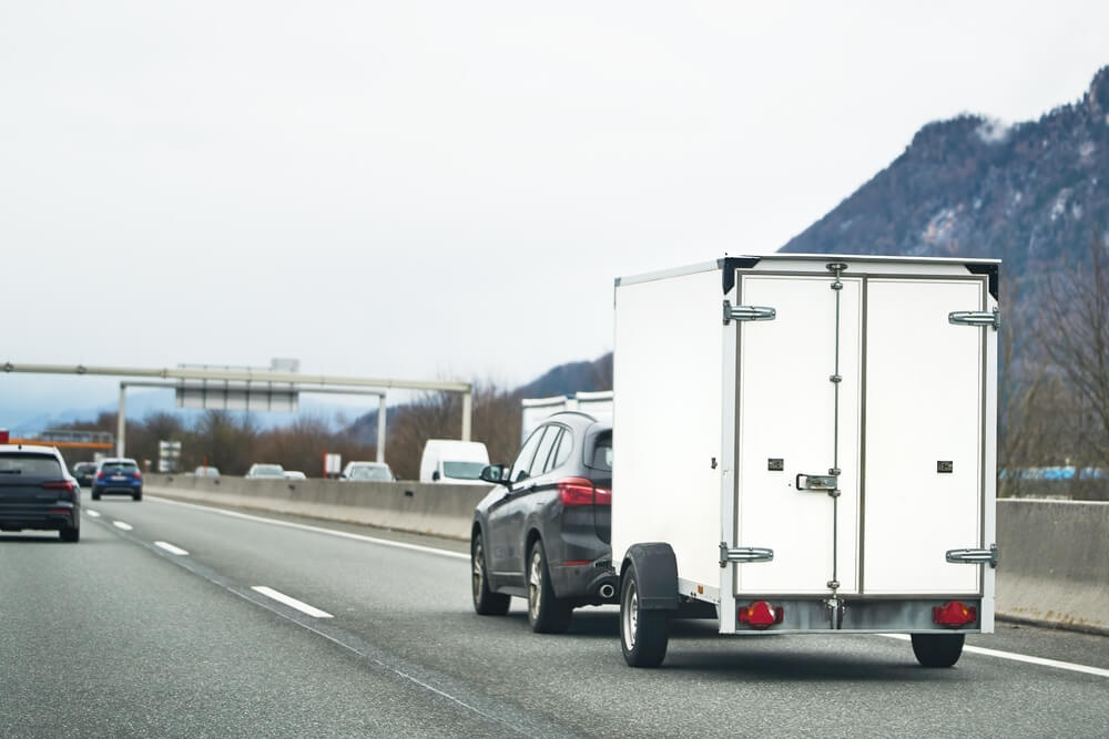 Car on a highway enjoying towing trailer insurance California.