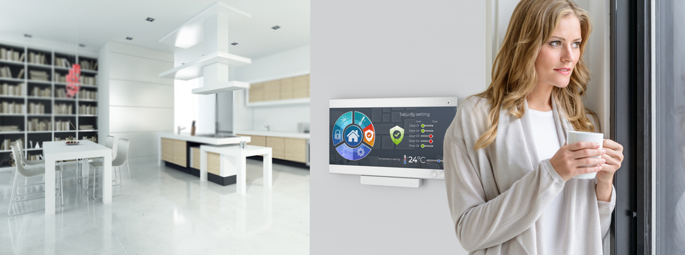Woman having coffee by a Home automation control station in a modern home.