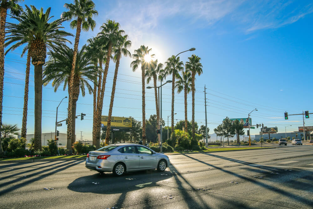 Two people talking inside a car, representing the need for extra insurance coverage during everyday driving situations.