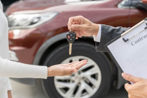 Handling car key after buying a car from a private seller, ready to search for car insurance in California.