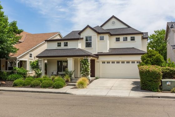 Two-story vacant California home with a landscaped front yard, covered porch, and attached garage, representing a property that may need specialized house insurance coverage.