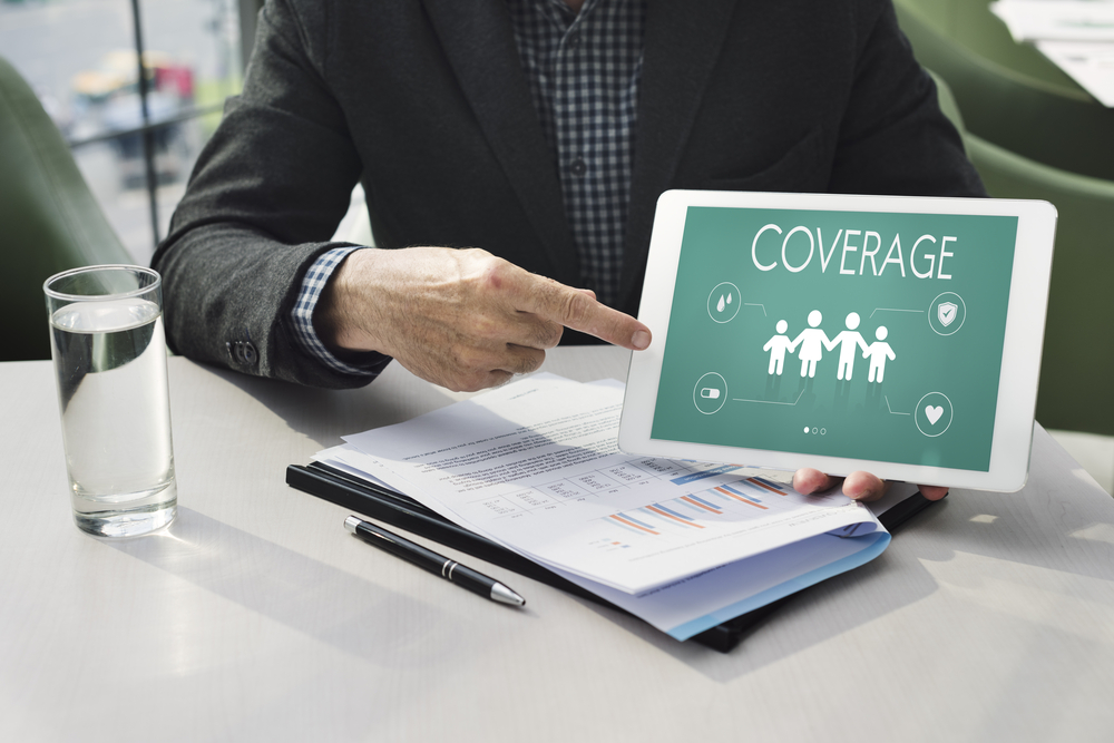 Insurance agent reviewing health insurance plan coverage on a tablet.