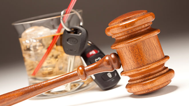 Alcoholic drink with car keys and mallet to represent a DUI