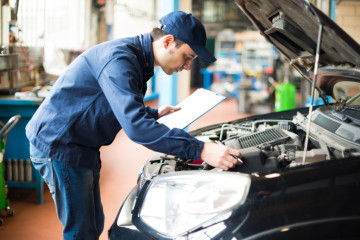 Portrait of a mechanic at work in his garage