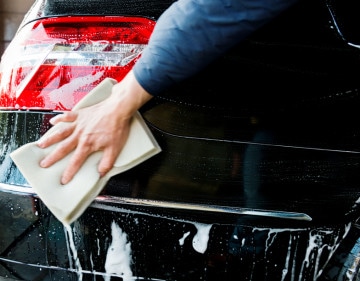 Washing a car with sponge..