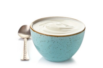 bowl of greek yogurt on a white background