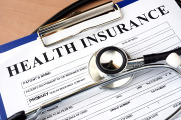 Close up of health insurance form with stethoscope