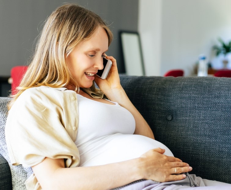 pregnant woman talking on a mobile phone telemedicine coronavirus