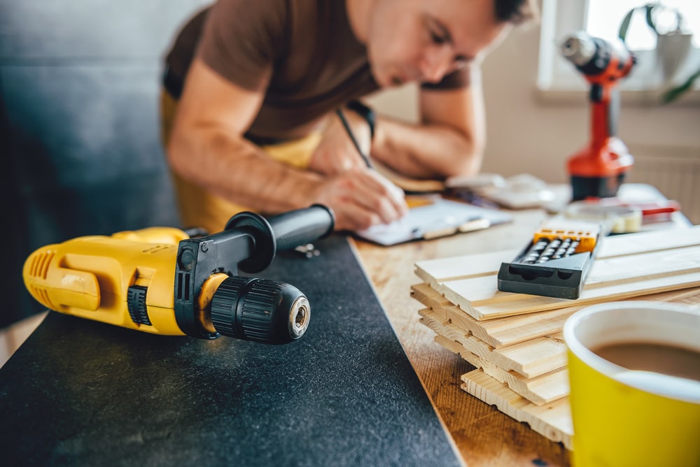 man updating floors while staying inside