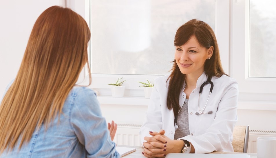 female doctor talking to patient during open enrollment california