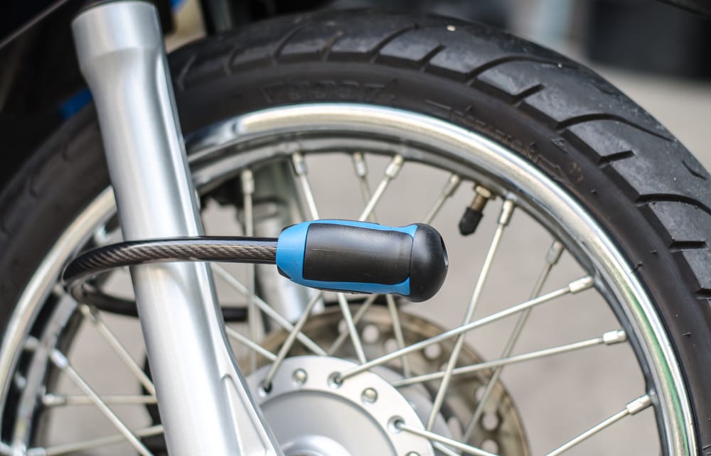 anti theft lock attached to motorcycle wheel