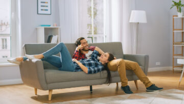 happy couple on the couch of their first rented apartment