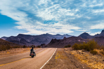 panoramic view of california road with a motorcycle