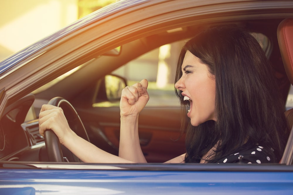 Side profile of an angry young driver bring unsafe