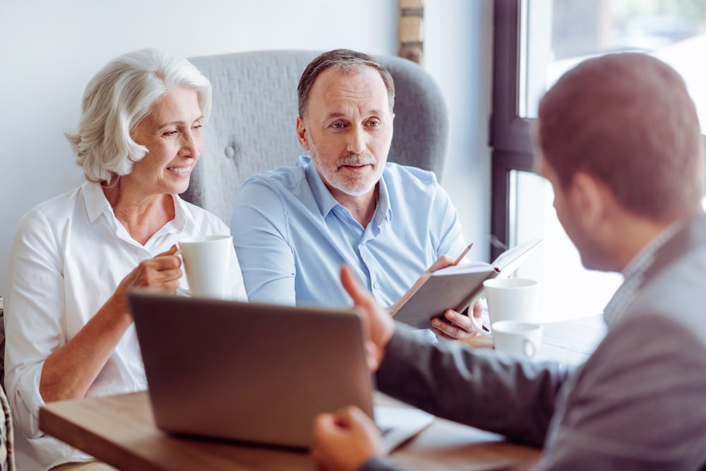 older couple with car insurance agent