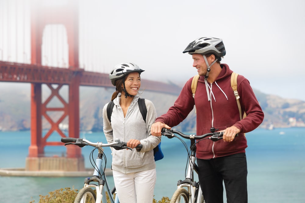 couple sightseeing in San Francisco, USA on bicycle