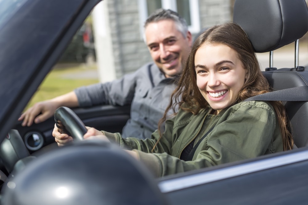 A teenager learning to drive or take a driving test