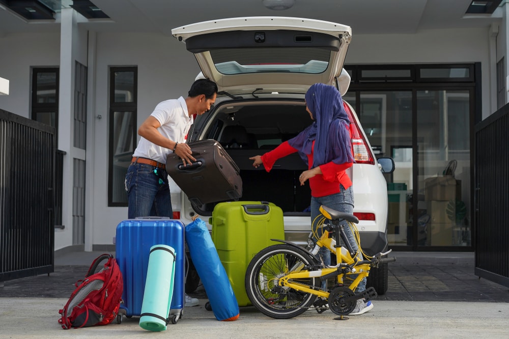 couple packing up car for road trip