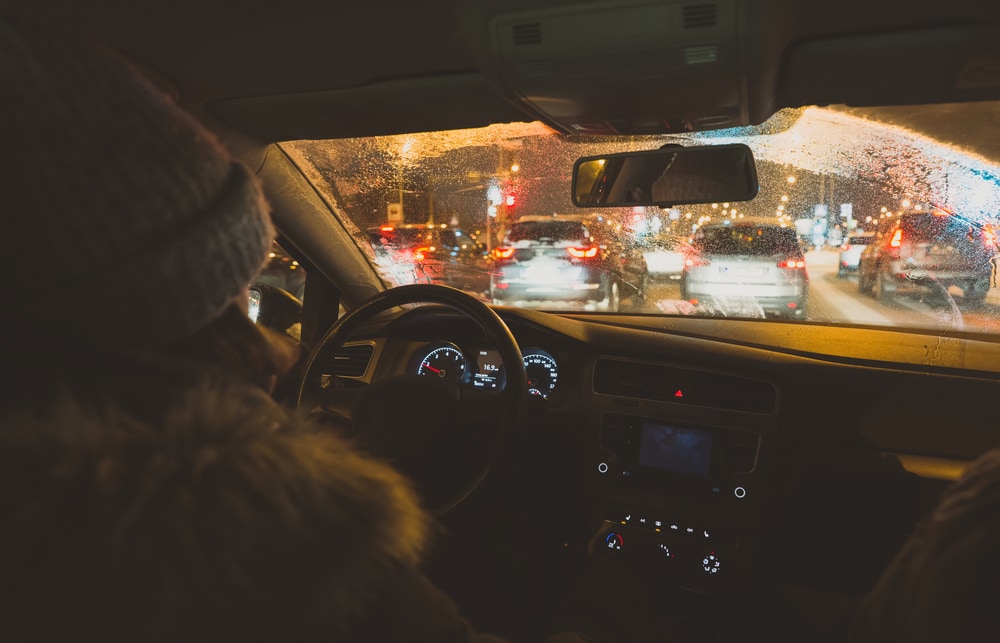man driving at night in traffic