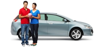 Man and woman in front of a parked car