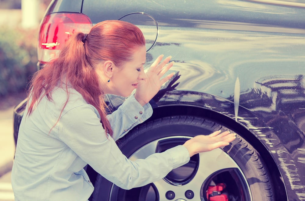 woman next to her car that was involved in a hit and run