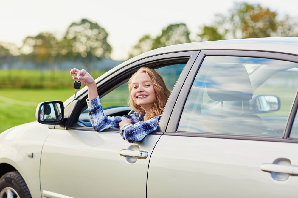 college teenage driver in driver's seat of car