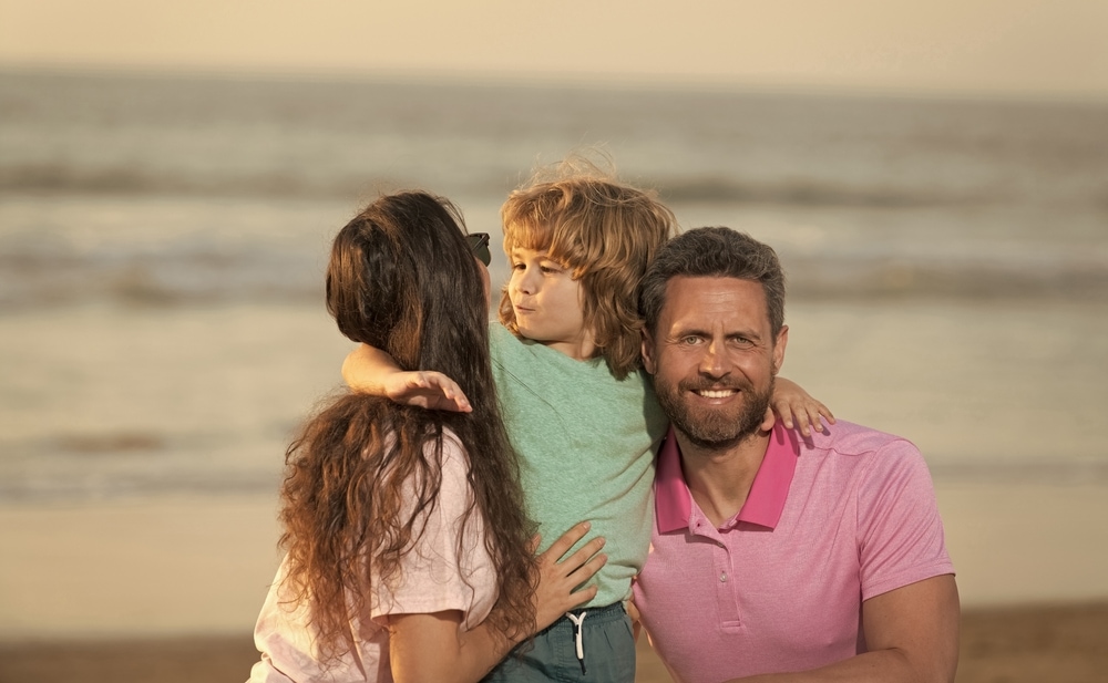 Couple on the beach with child