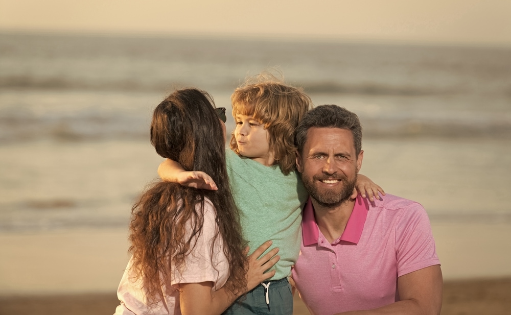 Couple on the beach with child