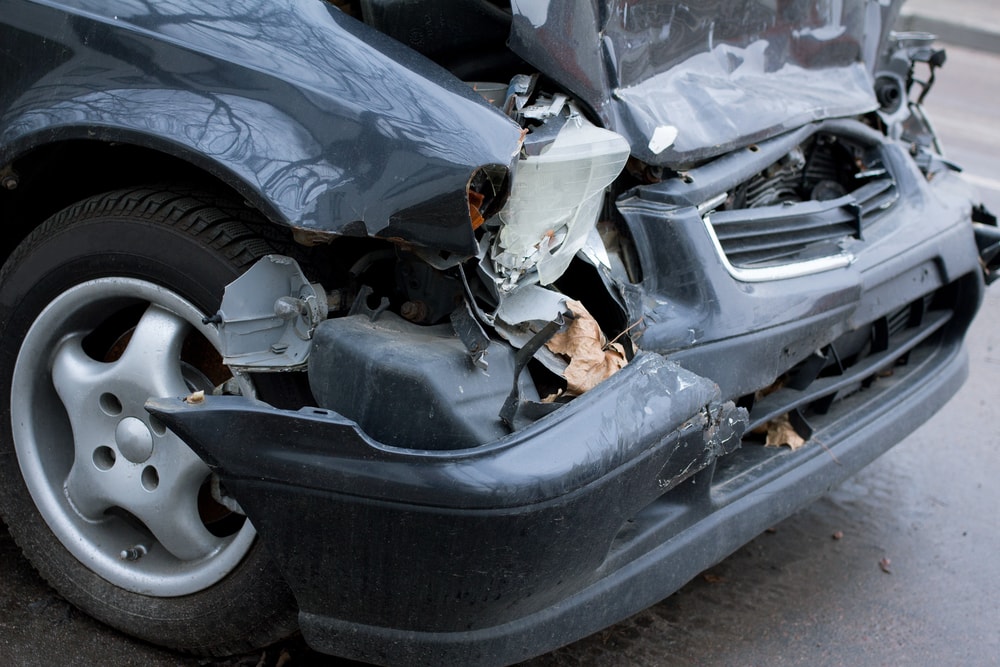 front of a salvaged car