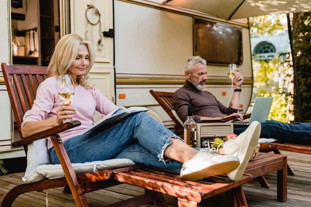 couples sitting outside rv
