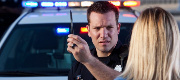 Woman getting a sobriety check from a police officer