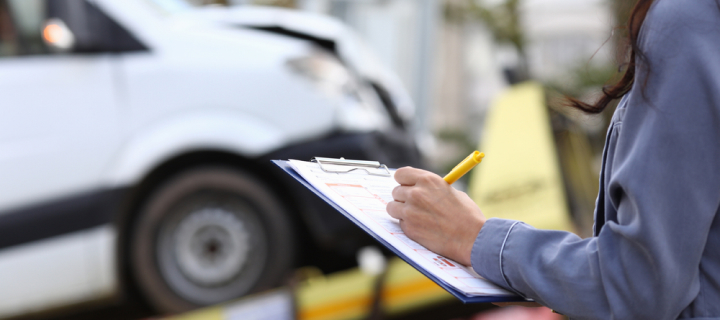 The insurance agent fills out the paperwork after an accident.