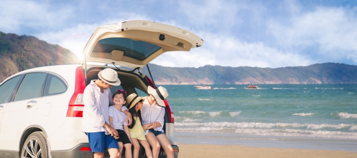 Happy family at sunny day on the peaceful beach.