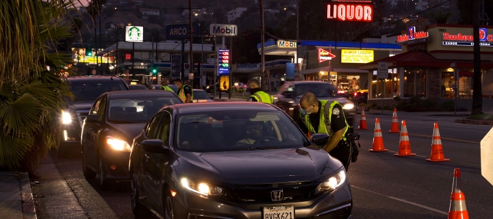 Los Angeles police officers question drivers at field sobriety check point on Sunset Blvd. at sunset.