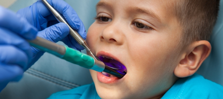 Small child at the dental office receiving dental care.