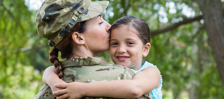 Soldier woman reunited with her daughter on a sunny day; she has a military auto insurance discount in California with Cost-U-Less. Cheap car insurance in California.
